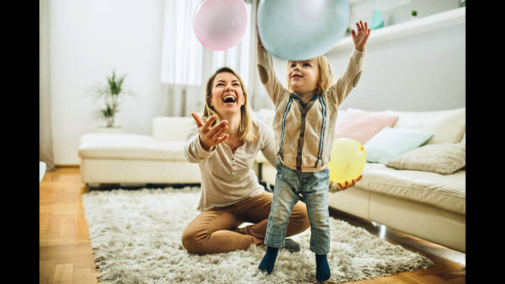 A woman playing a baloon game with a kid