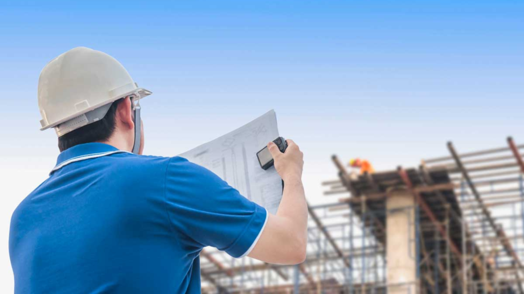 A building contractor looking at a building sketch