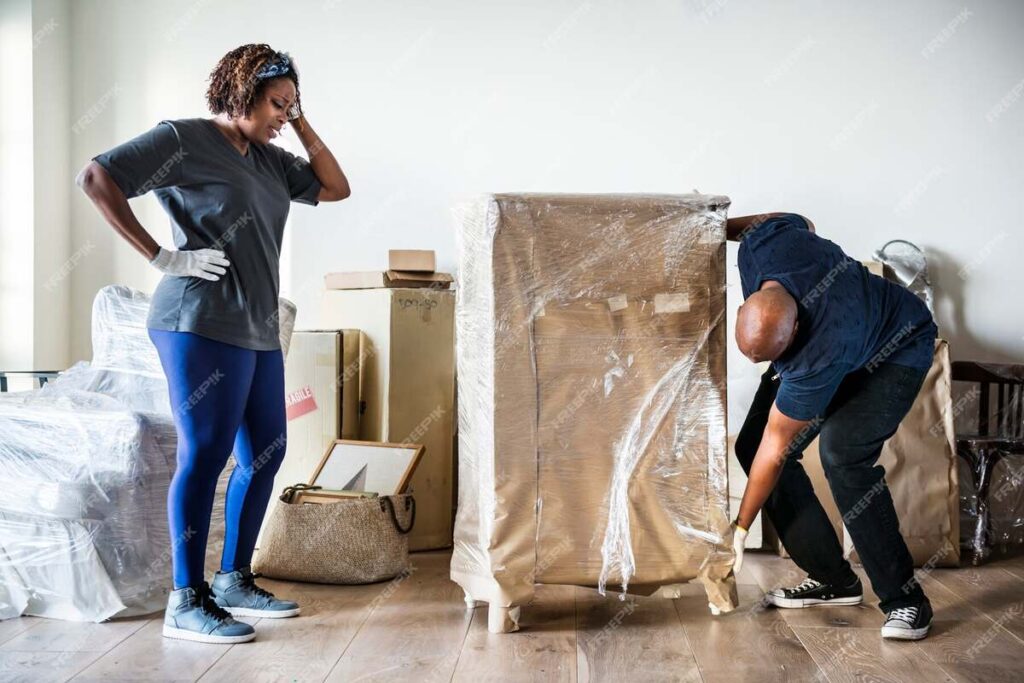 A couple unwrapping their furniture after moving into a new home