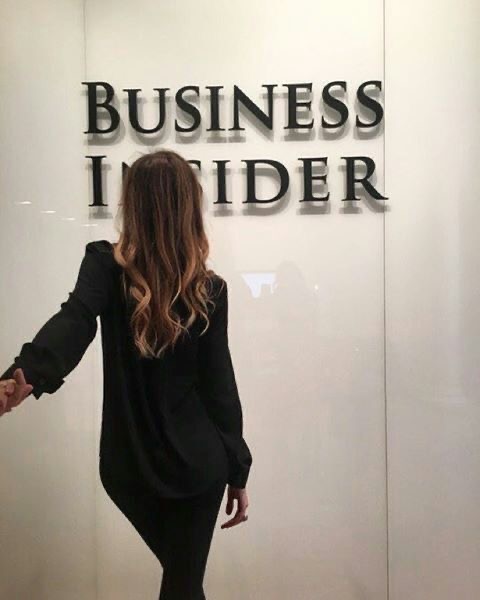 An image of a woman in front of a wall with business insider written on it