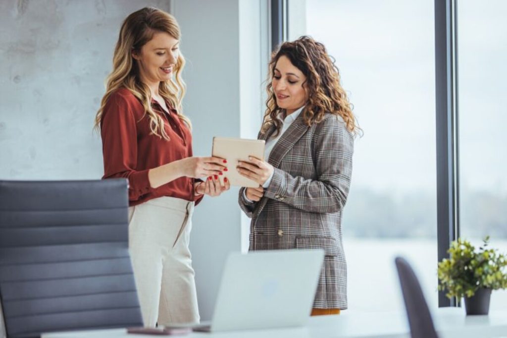 A sales representative pitching a client at their office